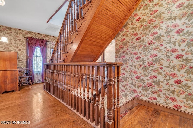 stairs with hardwood / wood-style floors