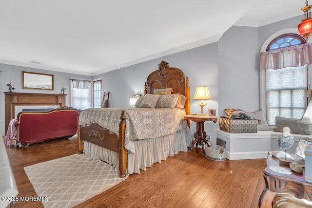 bedroom with crown molding and light hardwood / wood-style floors