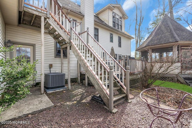 rear view of property with central AC and a wooden deck