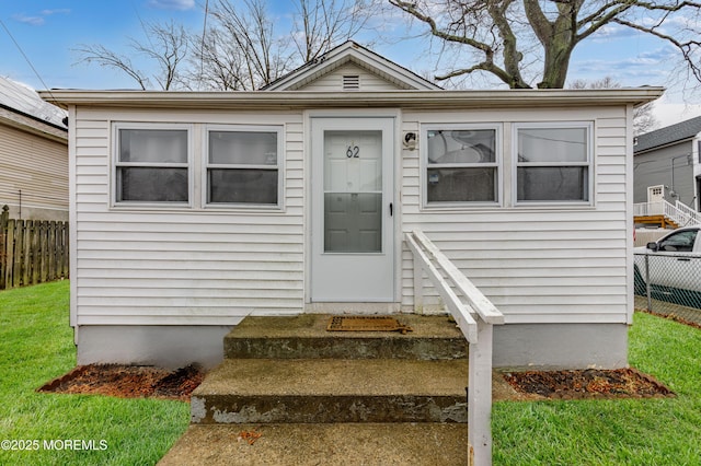 bungalow-style home featuring a front yard