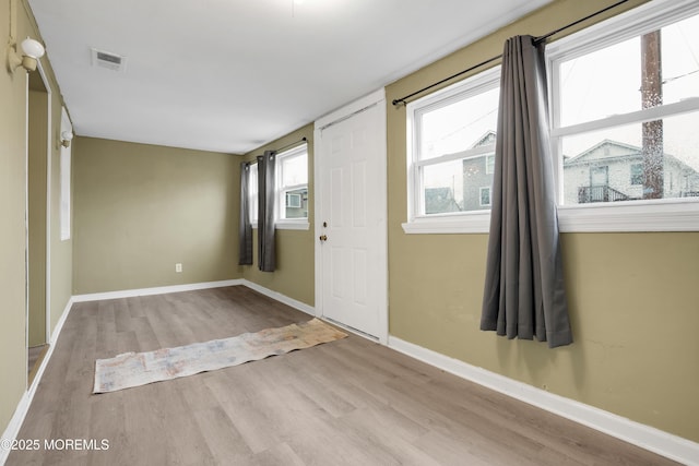 entrance foyer with light hardwood / wood-style floors and plenty of natural light