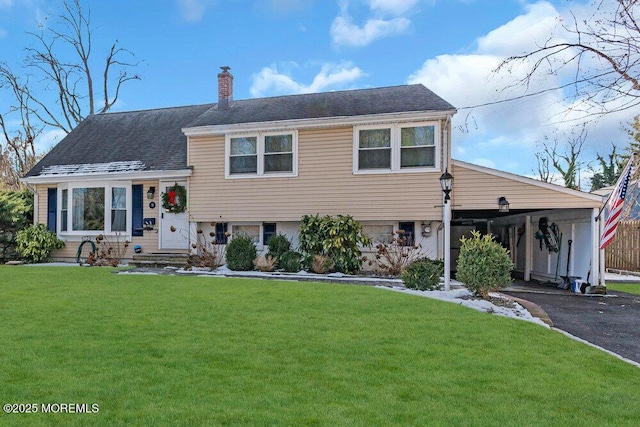 split level home featuring a carport and a front yard