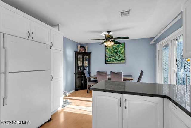 kitchen featuring white cabinetry, white appliances, light hardwood / wood-style floors, and ceiling fan