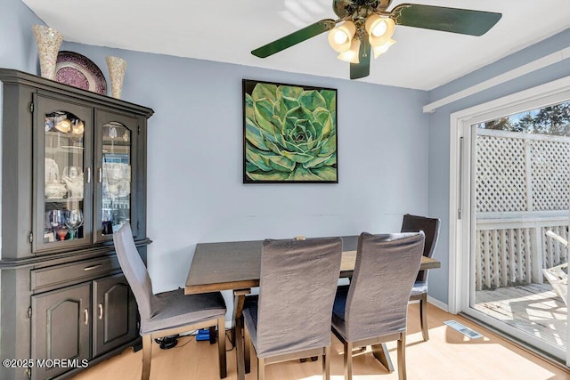 dining space featuring ceiling fan and light wood-type flooring