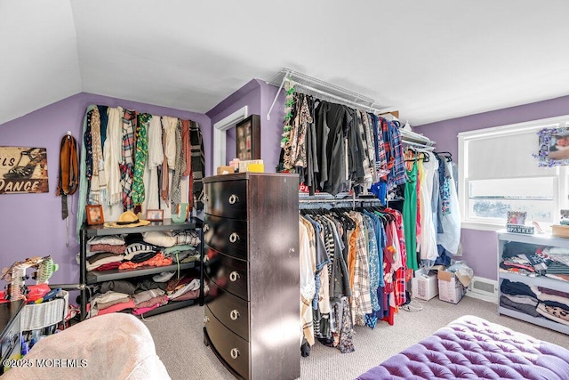 spacious closet with light carpet and lofted ceiling