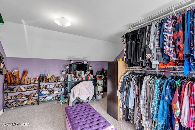 walk in closet with carpet flooring and vaulted ceiling