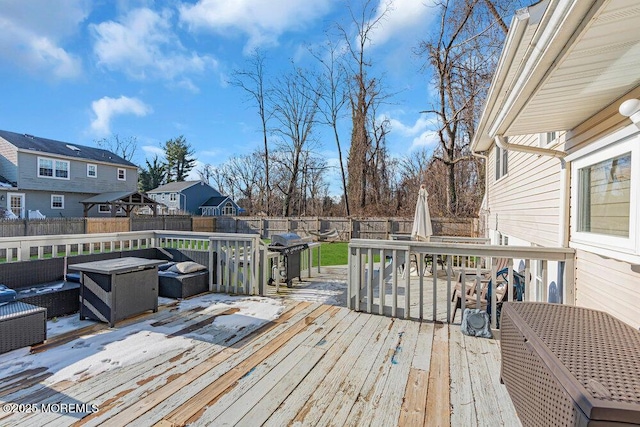 wooden terrace featuring a grill and an outdoor hangout area