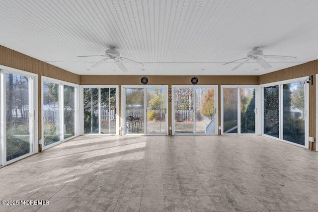 unfurnished sunroom featuring ceiling fan