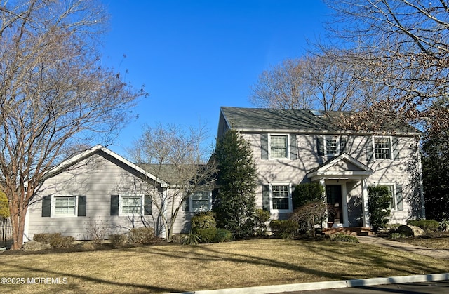 colonial-style house with a front lawn