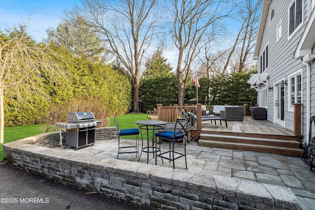 view of patio with a wooden deck, a grill, and outdoor lounge area