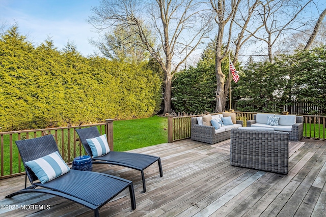 wooden terrace with outdoor lounge area and a yard