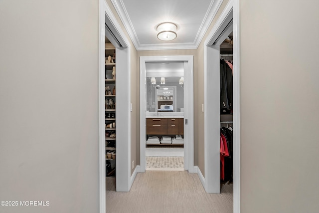 hall with ornamental molding and light carpet