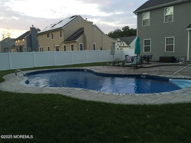 view of swimming pool with a yard and a patio area