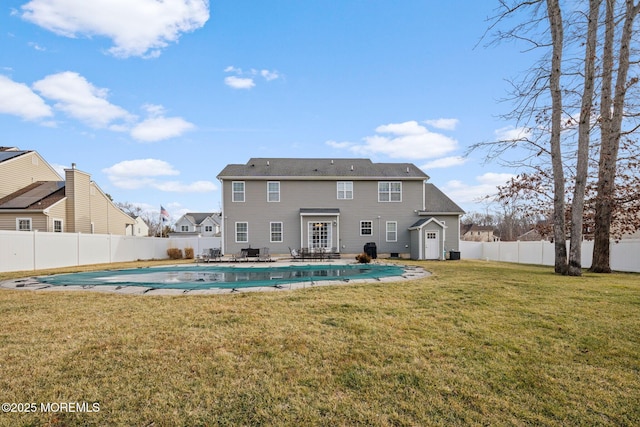 back of property featuring a yard, a covered pool, and a patio area