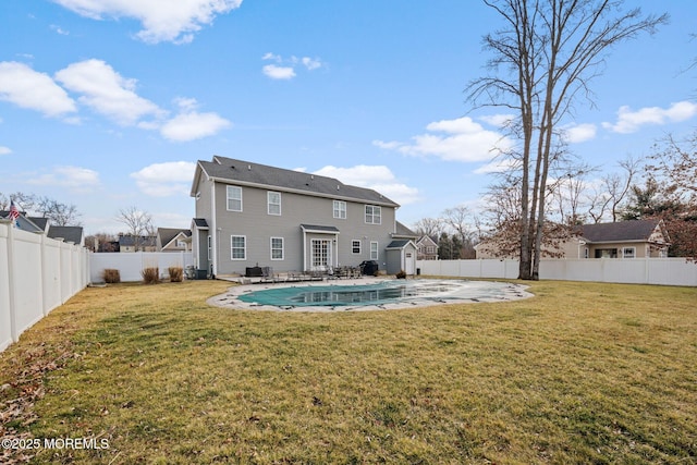 back of house featuring a patio, a covered pool, and a lawn