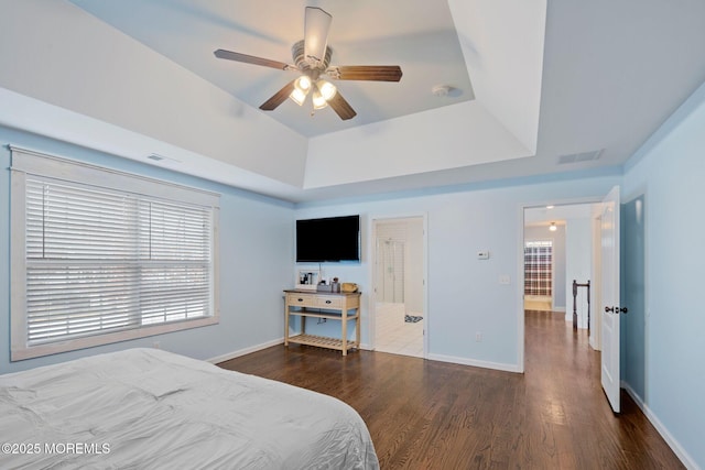 bedroom featuring ceiling fan, a raised ceiling, and hardwood / wood-style floors