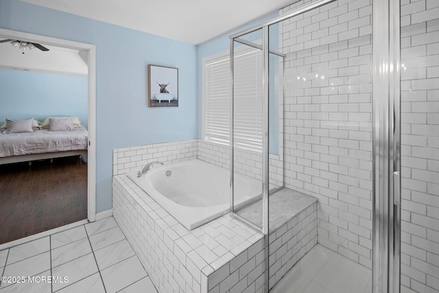 bathroom with separate shower and tub and ceiling fan