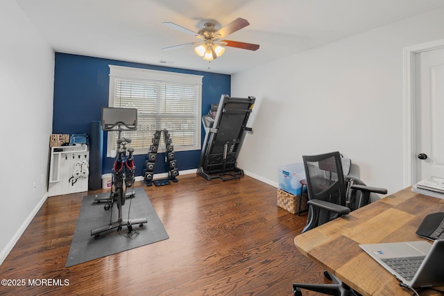 workout area with dark wood-type flooring and ceiling fan