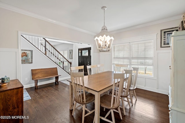 dining area with a notable chandelier, dark wood-type flooring, and ornamental molding