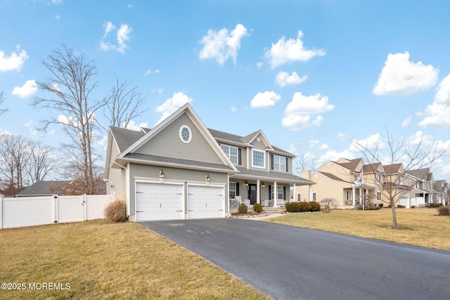 view of front of house featuring a porch, a garage, and a front lawn