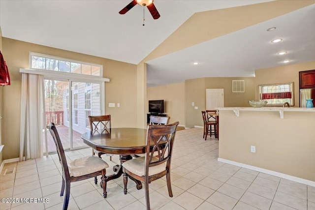 tiled dining area featuring lofted ceiling and ceiling fan