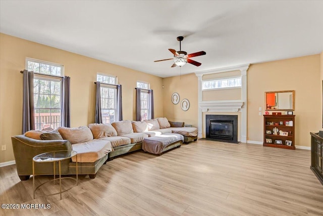 living room with ceiling fan and light wood-type flooring