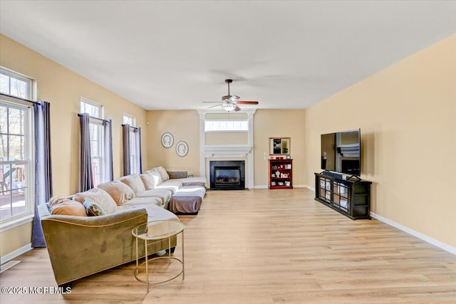 living room featuring ceiling fan and light wood-type flooring