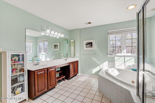 bathroom featuring tile patterned floors, vanity, and tiled tub