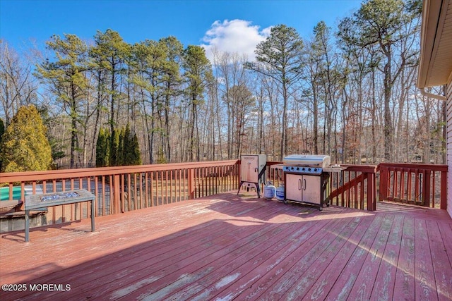 wooden terrace featuring a grill