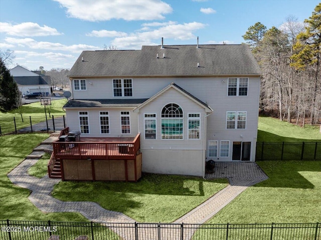 rear view of property with a wooden deck and a lawn