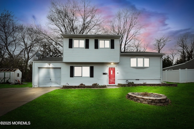 view of front of home with a yard and a garage