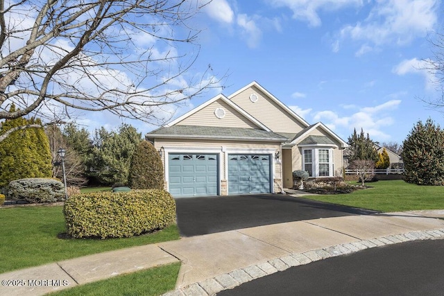 view of front of property with a garage and a front yard