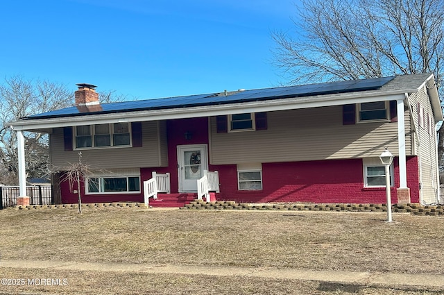 raised ranch featuring solar panels