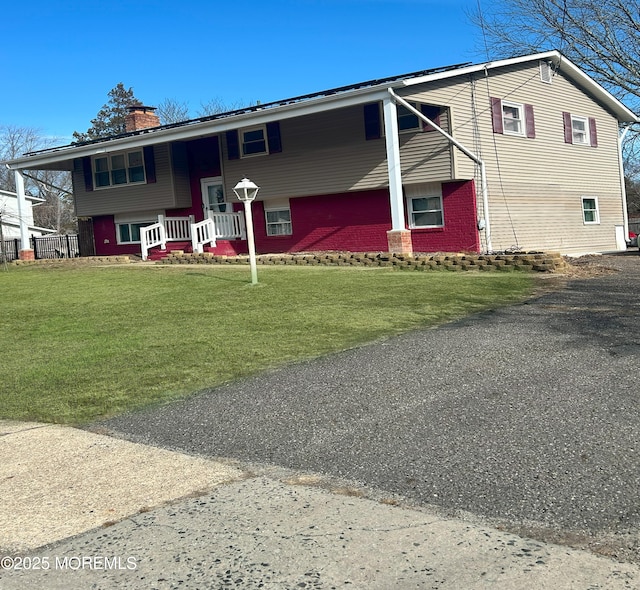 raised ranch with a front lawn