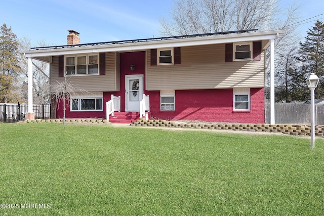 raised ranch with a front yard