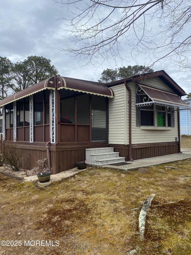 view of side of home featuring a yard