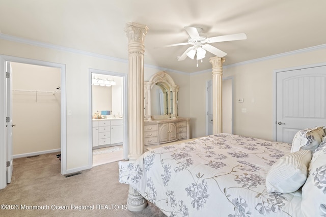 bedroom with a closet, a walk in closet, crown molding, and light colored carpet