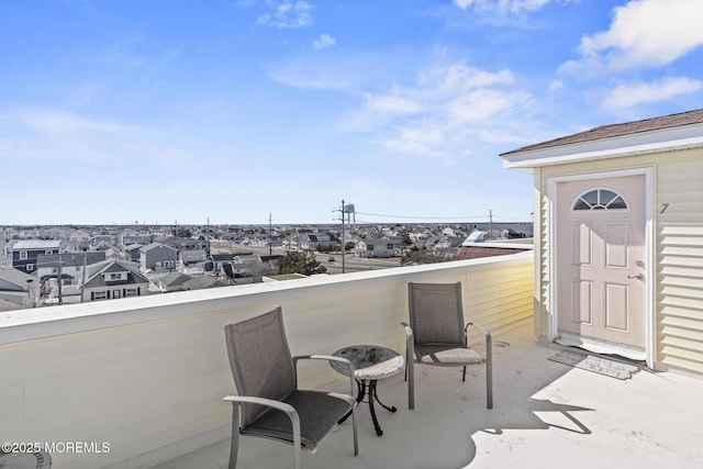 view of patio with a balcony and a residential view