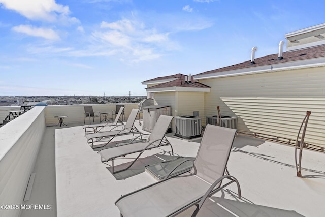 view of patio featuring a balcony and central AC