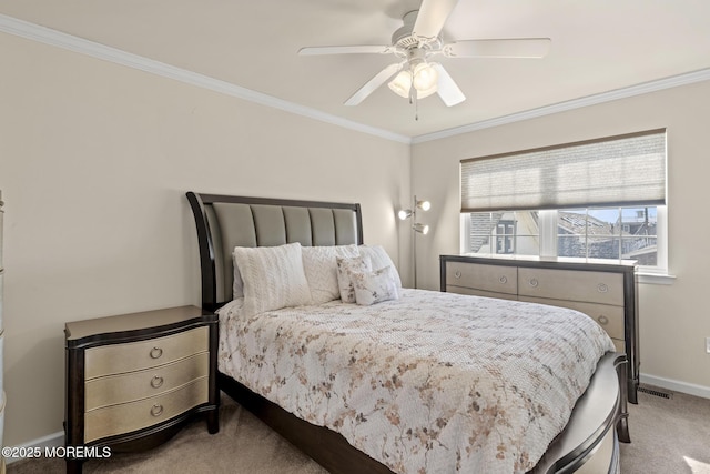 bedroom featuring carpet flooring, crown molding, baseboards, and ceiling fan