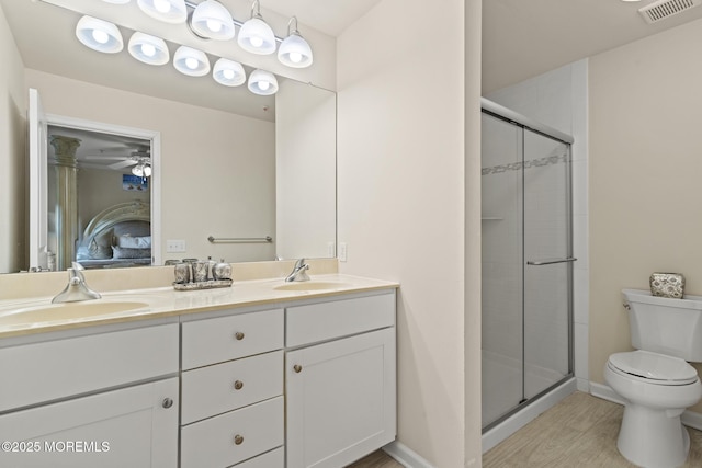 ensuite bathroom with visible vents, connected bathroom, a shower stall, and a sink