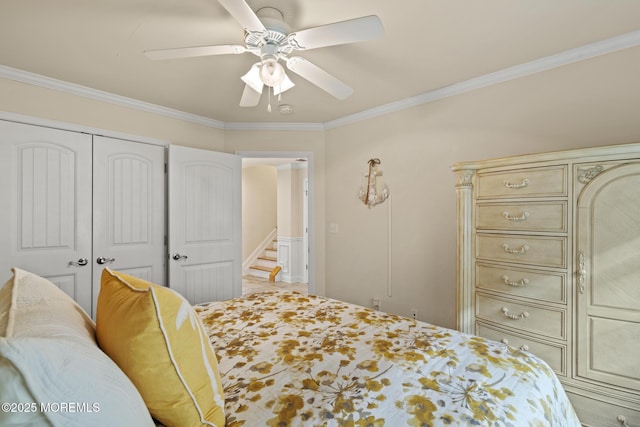 bedroom with ceiling fan, a closet, and crown molding