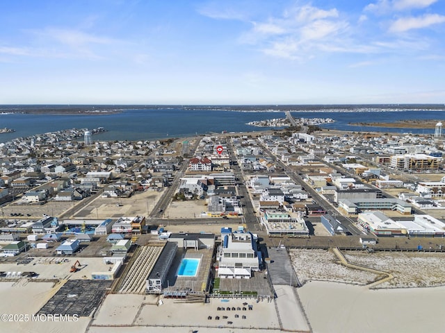 birds eye view of property with a water view and a city view