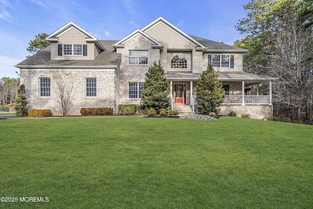 view of front of home featuring covered porch and a front lawn