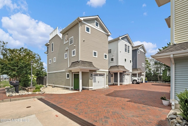 rear view of property featuring a garage