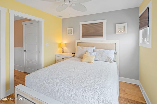 bedroom with ceiling fan and light wood-type flooring