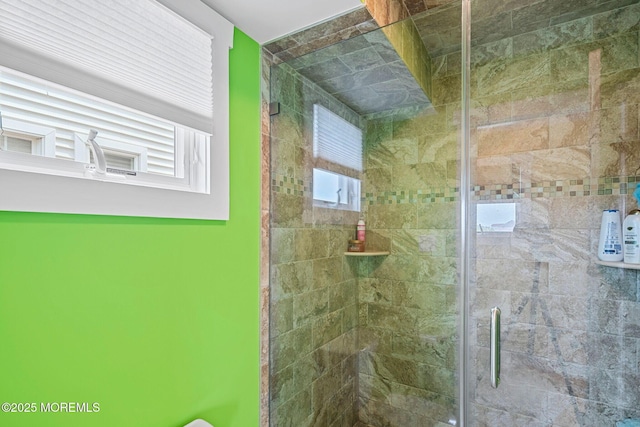 bathroom with a shower with door