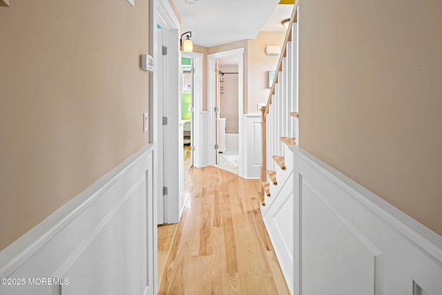 corridor with light hardwood / wood-style flooring