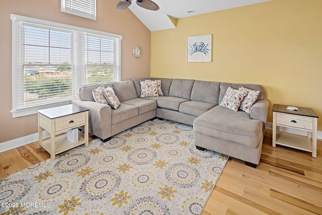 living room featuring hardwood / wood-style flooring, vaulted ceiling, and ceiling fan