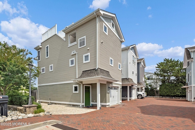 rear view of property with a garage